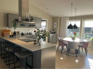 a kitchen and dining room with a table and chairs at New luxurious Villa in Helsingborg close to the City in Helsingborg