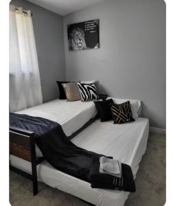 two twin beds in a room with a picture on the wall at Pool home in Las Vegas