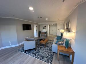 a living room with a couch and a table at B&J Hotels in Roswell