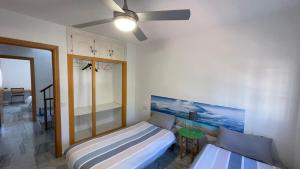 a bedroom with two beds and a ceiling fan at Casa Sol & Mar, Rincon de la Victoria, Malaga in Rincón de la Victoria +48 photos