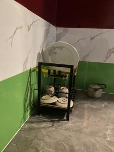 a shelf with plates and bowls in a room at Renova-Immo in Yaoundé +29 photos