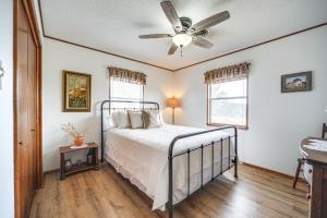 a bedroom with a bed and a ceiling fan at Historic Hoffmann Ranch Haus Near Wineries! in Fredericksburg