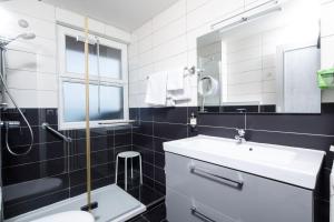 a bathroom with a sink and a toilet and a mirror at Saint Aubin Logis Hôtel & Restaurant in Saint-Aubin-sur-Mer