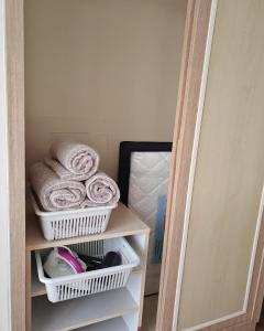 a closet with towels on a shelf next to a mirror at Urban Oasis Apartment 5 in Melaka