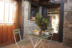 a table and two chairs in a room with a window at HOTEL RURAL SANTUI in Horcajuelo de la Sierra