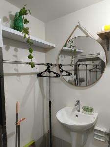 a bathroom with a sink and a mirror at Miranda's Suite by Fullerton in Silang