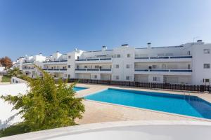 an apartment with a swimming pool in front of a building at Dream holidays @ Santa Luzia Tavira in Santa Luzia