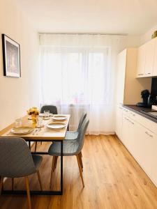 a dining room table and chairs in a kitchen with a window at Katy's Cozy Corner CityCenter in Graz +30 photos