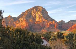 a mountain with a house in front of it at Luxe Boutique-Style Home w/Indoor Hot Tub in Sedona +49 photos