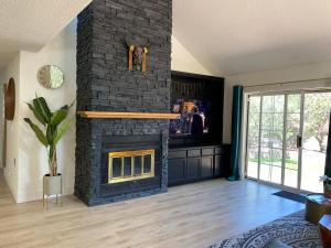 a living room with a fireplace and a tv at Luxe Boutique-Style Home w/Indoor Hot Tub in Sedona