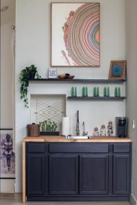 a kitchen with a black cabinet and a sink at Luxe Boutique-Style Home w/Indoor Hot Tub in Sedona