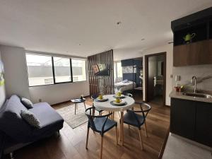 a living room with a couch and a table with chairs at Depto H360 in La Paz