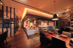 a kitchen and dining room with a table and chairs at Terrace Inn Katsuta in Hitachinaka