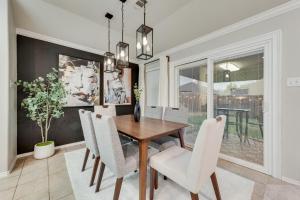 a dining room with a wooden table and white chairs at Luxury And Cozy Home 3BD, 2BATHS in Little Elm