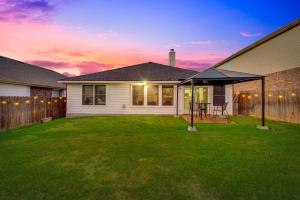 a house with a backyard with a table in the yard at Luxury And Cozy Home 3BD, 2BATHS in Little Elm