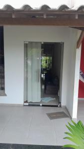 an open glass door of a house with a room at Casa no Guaibim in Valença