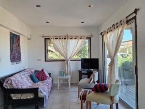 a bedroom with a bed and a desk and a window at casa sauce de portezuelo punta del este in Sauce de Portezuelo