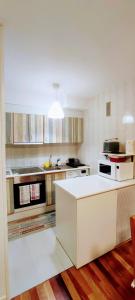 a kitchen with a white island in a room at Carlina Canfranc in Canfranc-Estación