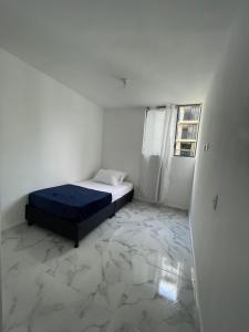 イバゲにあるapartamento 3 habitaciones con parqueaderoのベッドと窓のある白い部屋