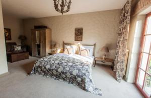 a bedroom with a large bed and a chandelier at Apartamenty Za Murem in Poznań