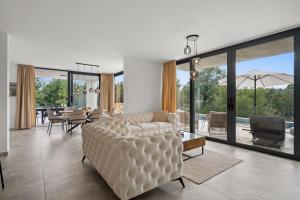 a living room with a couch and a table at Santalezi Sunset Villa - Nature and Private Pool in Santalezi