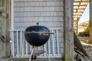 a grill on a stand in front of a house at Large Family Beach Rental at Oceanfront. in West Onslow Beach