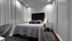 a bedroom with a bed with a black headboard at Sol y Brisa Resort Almerimar in Almerimar