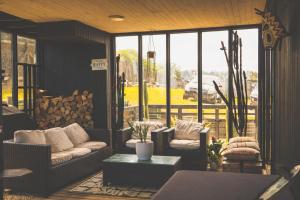 a screened in porch with couches and a table at Casa Alma - Lujo y descanso con vista al mar in Pichilemu