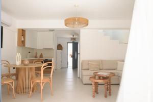 a kitchen and living room with a table and chairs at Pelagia's Loft Villas Haroupi & Rodi with Private Heated Pools, 5 Walking Distance to the Beach in Kavros +145 photos
