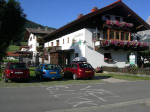 three cars parked in front of a building at Haus Mooshof in Lermoos