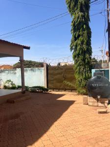a yard with a fence and a brick sidewalk at Résidence huele in Ouagadougou
