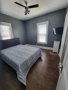 a bedroom with a bed and a ceiling fan at Lake Erie Beach Hutch in Port Clinton