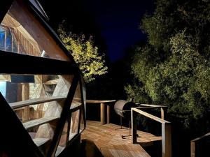 a view of a deck at night with a grill at Cabaña Domo Bosque Escondido in Recinto