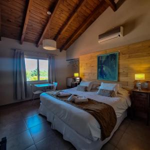 a bedroom with a large bed and a window at Hotel Antiguo Camino in Villa General Belgrano +85 photos