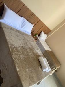 a bedroom with a bed with white pillows at Hotel Primavera Palace in Salinas +4 photos