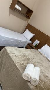 a hotel room with two beds with towels on the bed at Hotel Primavera Palace in Salinas
