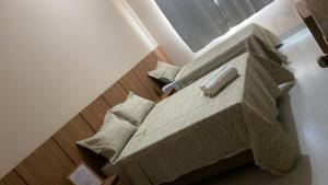 a bedroom with a bed with pillows on it at Hotel Primavera Palace in Salinas