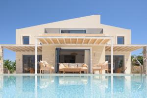 a villa with a swimming pool next to a house at Pelagia's Loft Villas Haroupi & Rodi with Private Heated Pools, 5 Walking Distance to the Beach in Kavros