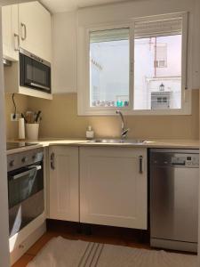 a kitchen with a sink and a window at Arcos de la Loba by casitasconencantoes in Medina Sidonia