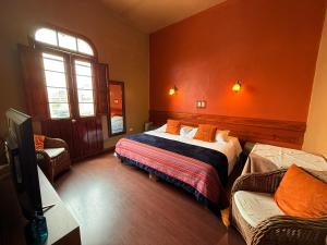 a bedroom with a bed and a tv in it at La Casona de Palacio Viejo in Arequipa