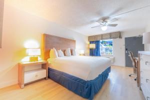 a hotel room with a large bed and a window at Ramada by Wyndham Flamingo Water Park in Kissimmee