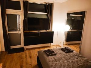 a bedroom with a bed and two large windows at SchaeBu! 2 Zwischen Uni & Zentrum in Cottbus