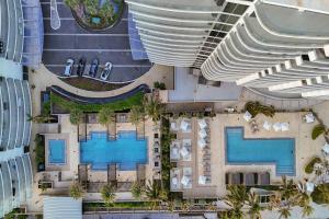 an overhead view of a resort with a swimming pool at 2BR Ocean Views Condo in West Palm in Riviera Beach