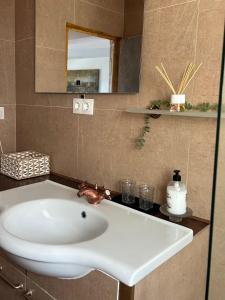 a white sink in a bathroom with a mirror at Vistas al mar, 1 min de la playa, Relax y WiFi in Fasnia +9 photos
