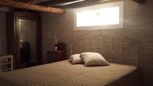 a bed with two pillows on it in a bedroom at Garibaldi home Fabrizia in Castellammare del Golfo