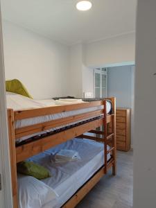 two bunk beds in a room with a mirror at Alice Home in Puebla de Farnals +25 photos
