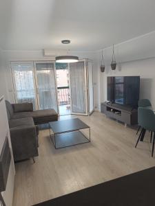 a living room with a couch and a table at Alice Home in Puebla de Farnals
