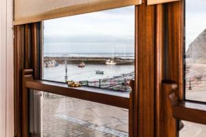 a view from a window of a harbor at Captain Cook's Cottage, Staithes, North Yorkshire in Staithes