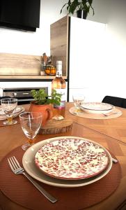 a table with a pizza on top of a table at Appartement Vannes Odyssée in Vannes