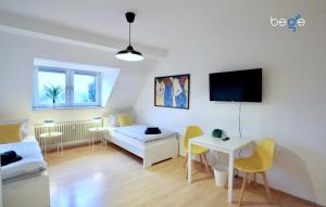 a living room with a couch and a table at BEGE APARTMENTS WorkLodge in Duisburg